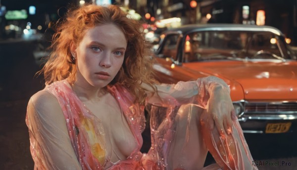 1girl,solo,long hair,breasts,looking at viewer,blue eyes,dress,cleavage,jewelry,medium breasts,sitting,earrings,parted lips,orange hair,blurry,lips,wet,see-through,no bra,night,depth of field,blurry background,wavy hair,ground vehicle,messy hair,wet clothes,pink dress,breasts apart,motor vehicle,freckles,knee up,realistic,nose,car,bokeh,city lights,brown hair,closed mouth,outdoors,curly hair