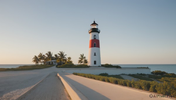 outdoors,sky,day,water,tree,blue sky,no humans,shadow,ocean,beach,building,scenery,sunset,sand,palm tree,horizon,road,bush,tower,shore,grass,watercraft,lamppost,evening,real world location,lighthouse