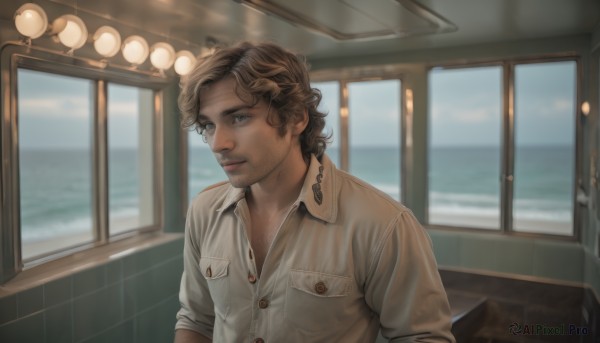 solo,looking at viewer,short hair,blue eyes,brown hair,shirt,1boy,sitting,closed mouth,white shirt,upper body,male focus,collared shirt,indoors,blurry,lips,window,buttons,facial hair,ocean,chair,beard,freckles,curly hair,pocket,realistic,stubble,breast pocket,blonde hair,parted lips,sky,day,cloud,water,sleeves rolled up,horizon