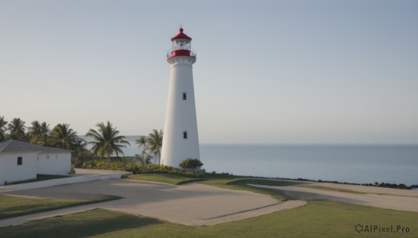 outdoors,sky,day,water,tree,blue sky,no humans,ocean,beach,grass,building,scenery,sand,palm tree,horizon,road,bush,tower,shore,lighthouse