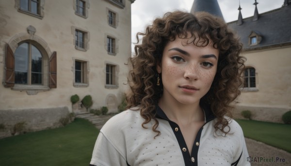 1girl,solo,long hair,looking at viewer,smile,brown hair,shirt,brown eyes,jewelry,white shirt,upper body,earrings,outdoors,parted lips,day,dark-skinned female,tree,lips,window,wavy hair,grass,building,freckles,curly hair,realistic,house,bangs,sky,medium hair,polka dot,messy hair,path,polka dot shirt