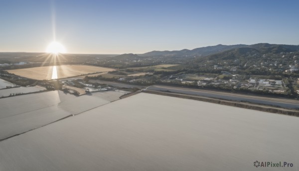 outdoors,sky,day,cloud,water,blue sky,no humans,sunlight,building,scenery,lens flare,sunset,mountain,city,sun,horizon,road,cityscape,river,landscape,mountainous horizon,sunrise,hill,desert