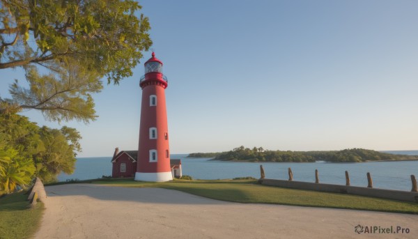 outdoors,sky,day,water,tree,blue sky,no humans,ocean,beach,grass,building,nature,scenery,fence,horizon,clock,road,bush,house,tower,shore,path,sunset,lighthouse