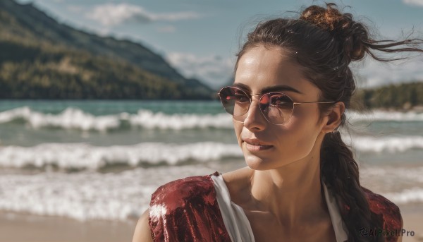 1girl,solo,long hair,brown hair,black hair,hair ornament,closed mouth,collarbone,upper body,outdoors,sky,glasses,day,dark skin,water,hair bun,mole,blurry,lips,depth of field,blurry background,ocean,beach,sunglasses,portrait,realistic,nose,round eyewear,sand,aviator sunglasses,cloud,looking to the side,wind,forehead,mountain,mole on cheek