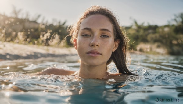 1girl, solo, long hair, looking at viewer, brown hair, brown eyes, closed mouth, outdoors, day, water, mole, blurry, lips, depth of field, blurry background, partially submerged, freckles, realistic