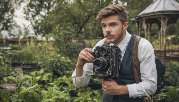 solo,short hair,brown hair,shirt,long sleeves,1boy,holding,brown eyes,white shirt,upper body,male focus,outdoors,necktie,day,collared shirt,bag,blurry,vest,tree,blurry background,facial hair,backpack,plant,beard,realistic,camera,holding camera,looking at viewer,parted lips,leaf,black vest,blue vest,undercut,photo background,brown bag