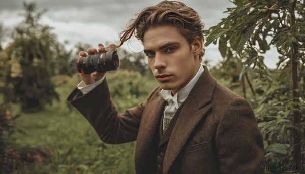 solo,looking at viewer,short hair,brown hair,shirt,long sleeves,1boy,holding,brown eyes,jewelry,jacket,white shirt,upper body,male focus,outdoors,parted lips,necktie,day,collared shirt,blurry,tree,blurry background,facial hair,formal,suit,nature,forest,brown jacket,realistic,camera,holding camera,blue eyes,cloud,hand up,vest,lips,leaf,binoculars