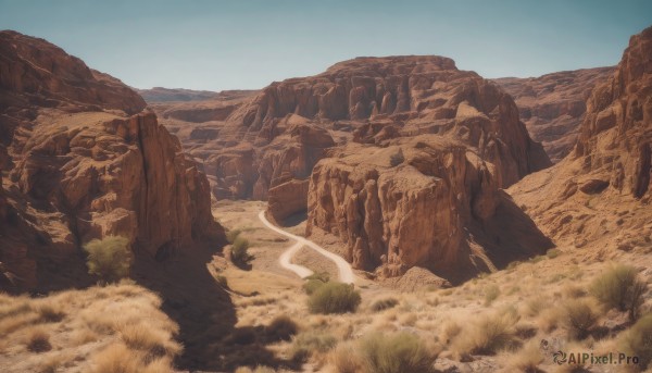 outdoors,sky,day,tree,blue sky,no humans,grass,nature,scenery,rock,mountain,sand,landscape,desert,cliff