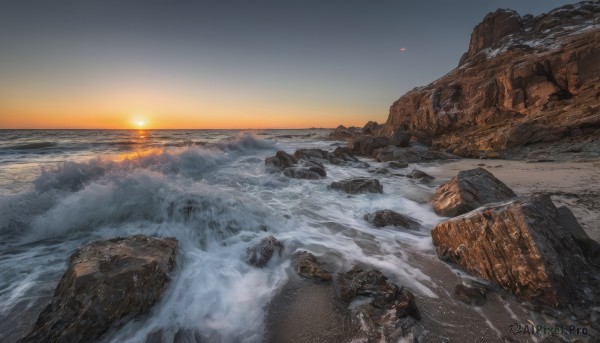 outdoors,sky,cloud,water,no humans,ocean,beach,scenery,sunset,rock,mountain,sand,sun,horizon,waves,shore,orange sky,sunrise,cliff,snow,landscape,gradient sky