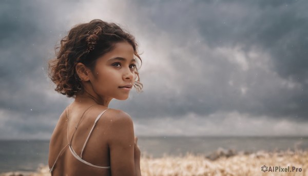 1girl,solo,looking at viewer,short hair,brown hair,black hair,bare shoulders,brown eyes,swimsuit,upper body,outdoors,sky,day,looking back,cloud,dark skin,from behind,blurry,dark-skinned female,lips,wet,blurry background,ocean,cloudy sky,freckles,curly hair,realistic,nose,spaghetti strap,field,very dark skin,hair ornament,jewelry,flower,sunlight,wind