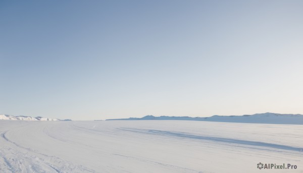 monochrome,outdoors,sky,day,blue sky,no humans,beach,scenery,mountain,sand,horizon,road,landscape,mountainous horizon,shore,desert,water,ocean,snow,blue theme,footprints