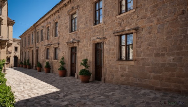 outdoors,sky,day,tree,blue sky,no humans,window,shadow,plant,building,scenery,door,potted plant,road,bush,wall,house,brick wall,street,flower pot,balcony,pavement,chimney