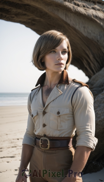 1girl,solo,short hair,brown hair,shirt,brown eyes,standing,white shirt,cowboy shot,outdoors,parted lips,day,collared shirt,belt,pants,blurry,tree,lips,looking to the side,tattoo,buttons,blurry background,ocean,beach,buckle,sleeves rolled up,clenched hands,freckles,pocket,black belt,rock,realistic,sand,breast pocket,brown pants,dirty,blonde hair,1boy,male focus,desert