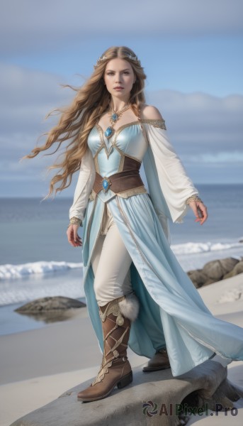 1girl,solo,long hair,breasts,looking at viewer,brown hair,hair ornament,long sleeves,dress,bare shoulders,brown eyes,jewelry,medium breasts,standing,full body,boots,outdoors,sky,day,pants,necklace,blue sky,lips,blue dress,beach,brown footwear,knee boots,gem,rock,realistic,white pants,sand,braid,cloud,water,cape,blurry,fur trim,blurry background,ocean,ring,fur-trimmed boots