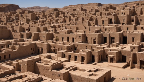 monochrome,outdoors,sky,day,blue sky,no humans,building,scenery,mountain,city,sand,road,cityscape,landscape,desert,rock,ruins,sepia,castle