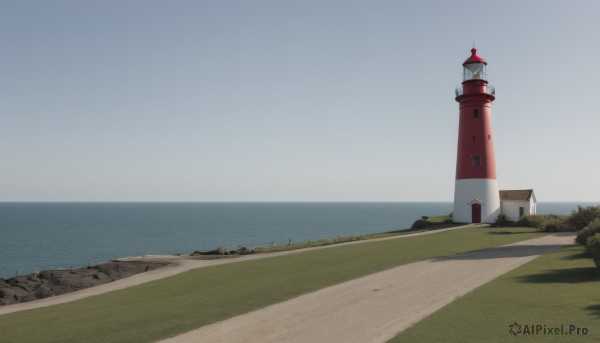 outdoors,sky,day,water,tree,blue sky,no humans,shadow,ocean,grass,building,scenery,mountain,horizon,road,river,castle,tower,landscape,mountainous horizon,shore,path,hill,beach,bush,house,lighthouse