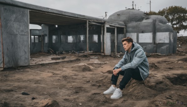 solo,short hair,brown hair,long sleeves,1boy,sitting,jacket,male focus,outdoors,shoes,day,pants,hood,tree,hoodie,black pants,white footwear,hood down,blue jacket,building,sneakers,grey jacket,wide shot,photo background,black hair,sky,scenery,realistic,ruins,grey sky