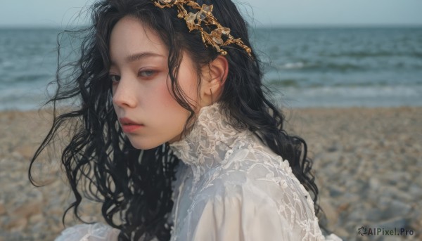 1girl,solo,long hair,looking at viewer,shirt,black hair,hair ornament,dress,white shirt,upper body,outdoors,parted lips,day,white dress,blurry,black eyes,from side,lips,grey eyes,depth of field,blurry background,ocean,wavy hair,beach,messy hair,portrait,curly hair,realistic,nose,sand,closed mouth,sky,water,blue sky,looking to the side,expressionless,photo background,shore