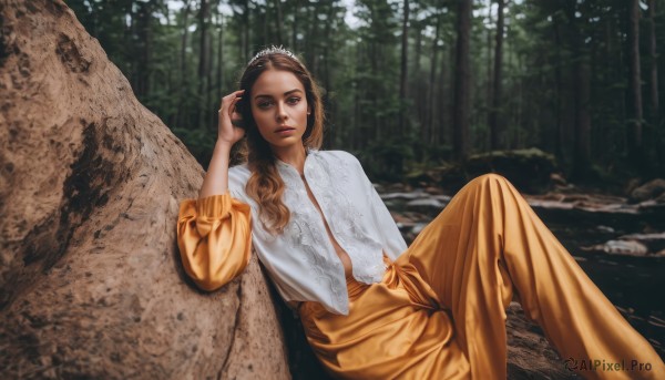 1girl,solo,long hair,looking at viewer,brown hair,long sleeves,dress,brown eyes,sitting,outdoors,day,hand up,blurry,tree,lips,tiara,nature,forest,knee up,rock,realistic,blue eyes,shirt,jewelry,white shirt,earrings,parted lips,pants,dark-skinned female,sunlight,blouse,scenery,leaning back,orange pants