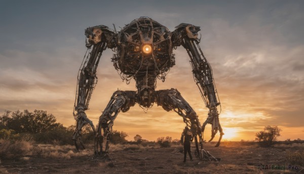 A male framed by the beauty of a majestic sunset outdoors