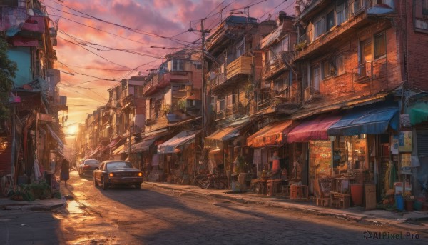 A motor vehicle set against the backdrop of a captivating sunset outdoors