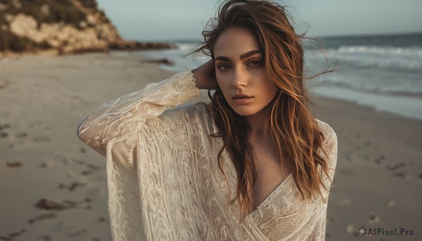 1girl,solo,long hair,breasts,looking at viewer,brown hair,shirt,long sleeves,cleavage,brown eyes,medium breasts,upper body,outdoors,parted lips,day,dark skin,water,blurry,arm up,sweater,dark-skinned female,lips,depth of field,blurry background,ocean,beach,messy hair,freckles,realistic,sand,thick eyebrows,wind,arm behind head,shore