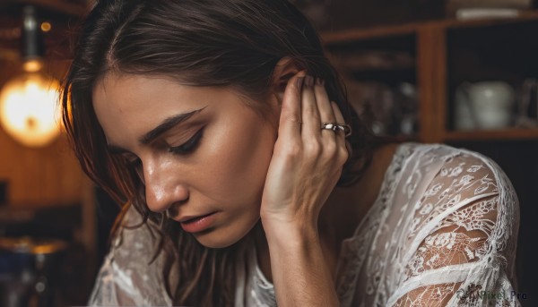 1girl,solo,long hair,brown hair,shirt,black hair,jewelry,closed mouth,closed eyes,white shirt,upper body,indoors,hand up,blurry,lips,depth of field,blurry background,looking down,ring,lace,realistic,nose,adjusting hair,wedding ring,hair tucking,earrings