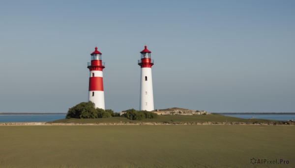 outdoors,sky,day,tree,blue sky,no humans,grass,building,scenery,road,bush,castle,tower,landscape,water,ocean,beach,nature,forest,sand,horizon,field,lighthouse