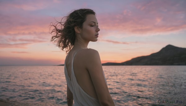 1girl,solo,short hair,black hair,dress,bare shoulders,upper body,outdoors,parted lips,sky,sleeveless,cloud,medium hair,water,white dress,mole,from side,lips,profile,floating hair,ocean,beach,wind,freckles,sunset,realistic,nose,horizon,looking at viewer,dark skin,dark-skinned female,cloudy sky,curly hair,mountain,evening