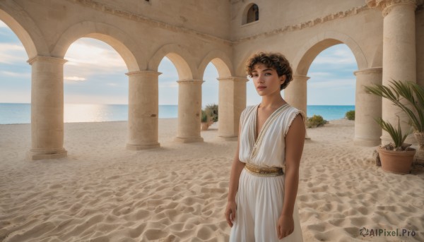 1girl,solo,looking at viewer,short hair,brown hair,1boy,dress,brown eyes,closed mouth,standing,outdoors,sky,sleeveless,day,cloud,dark skin,water,white dress,dark-skinned female,blue sky,lips,ocean,beach,plant,scenery,androgynous,robe,arms at sides,horizon,potted plant,pillar,tunic,arch,column,greek clothes,smile,male focus,parted lips,bare arms,curly hair,sand