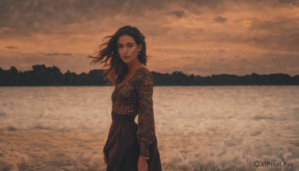 1girl,solo,long hair,looking at viewer,skirt,brown hair,shirt,black hair,long sleeves,brown eyes,jewelry,closed mouth,standing,cowboy shot,earrings,outdoors,sky,cloud,black skirt,water,from side,lips,looking to the side,floating hair,ocean,beach,cloudy sky,wind,scenery,sunset,horizon,waves,breasts,small breasts,medium hair,makeup,expressionless,lipstick,forehead,long skirt,sand,arms at sides,red lips,lake,shore,brown theme