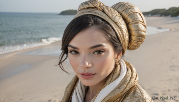 1girl,solo,looking at viewer,smile,short hair,brown hair,black hair,brown eyes,jewelry,closed mouth,earrings,outdoors,day,hair bun,blurry,lips,blurry background,ocean,beach,portrait,freckles,realistic,nose,sand,desert,bangs,water,shore