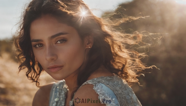 1girl,solo,long hair,looking at viewer,brown hair,black hair,dress,bare shoulders,brown eyes,jewelry,closed mouth,upper body,earrings,outdoors,sleeveless,dark skin,medium hair,blurry,dark-skinned female,lips,looking to the side,eyelashes,depth of field,blurry background,blue dress,wavy hair,portrait,freckles,curly hair,realistic,nose,necklace,wind