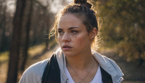 1girl,solo,short hair,brown hair,shirt,black hair,brown eyes,jewelry,white shirt,upper body,outdoors,parted lips,day,necklace,hair bun,blurry,tree,lips,looking to the side,depth of field,blurry background,looking away,sunlight,single hair bun,portrait,freckles,realistic,jacket,earrings,backlighting,nose,earphones,earbuds