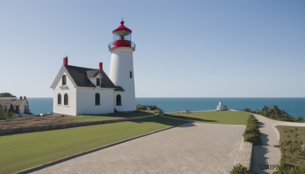 outdoors,sky,day,water,tree,blue sky,no humans,window,shadow,ocean,beach,grass,building,scenery,horizon,road,house,boat,shore,cloud,bush,wall,tower,landscape,path,lighthouse