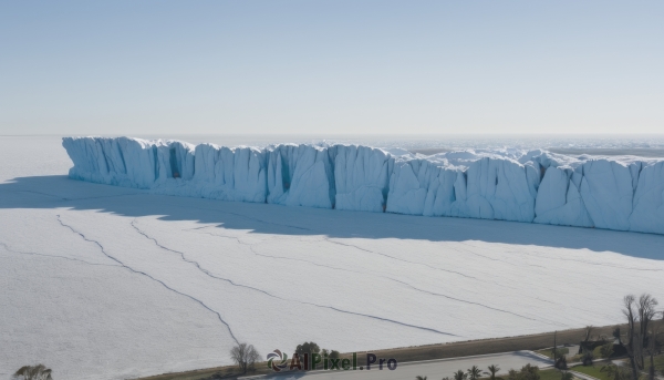 outdoors,sky,day,water,tree,blue sky,no humans,ocean,beach,grass,scenery,mountain,sand,horizon,road,landscape,shore,shadow,plant,snow,ice,rock,cliff