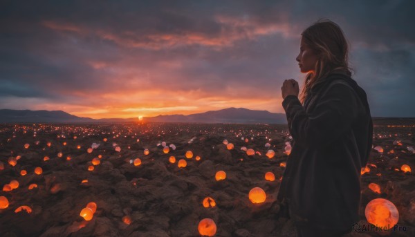 A stunning portrayal of a female in a breathtaking sunset outdoors