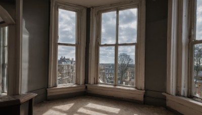 outdoors,sky,day,cloud,indoors,tree,blue sky,book,no humans,window,shadow,chair,table,cloudy sky,curtains,building,scenery,snow,city,door,cityscape,house,winter,bare tree,newspaper,wall