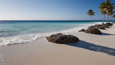 outdoors,sky,day,water,tree,blue sky,no humans,shadow,ocean,beach,scenery,rock,sand,palm tree,horizon,waves,shore,cloud