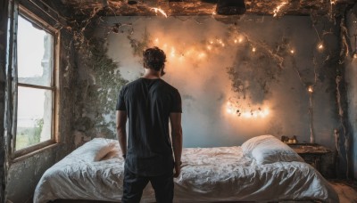 solo,short hair,shirt,black hair,1boy,standing,short sleeves,male focus,pants,indoors,from behind,tree,pillow,black shirt,window,bed,on bed,black pants,sunlight,plant,t-shirt,scenery,jeans,realistic,arms at sides,facing away,bedroom,lamp