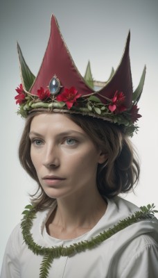 1girl,solo,short hair,blue eyes,simple background,brown hair,hat,white background,jewelry,closed mouth,upper body,flower,lips,looking up,plant,gem,portrait,freckles,realistic,nose,witch hat,leaf,head wreath