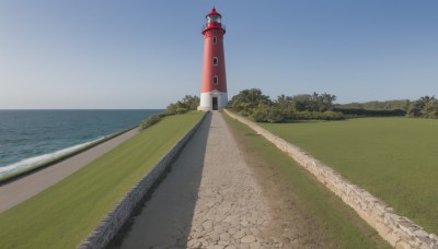 outdoors,sky,day,cloud,water,tree,blue sky,no humans,shadow,ocean,beach,grass,scenery,sand,horizon,clock,road,tower,landscape,shore,path,lighthouse,building,nature,bush