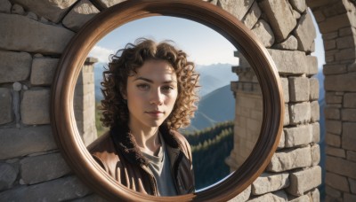 1girl,solo,looking at viewer,brown hair,shirt,brown eyes,jewelry,closed mouth,jacket,upper body,outdoors,sky,day,necklace,lips,black jacket,reflection,curly hair,mirror,mountain,realistic,nose,wall,leather,leather jacket,smile,short hair,earrings,tree,blue sky,window,sunlight,portrait,brick wall