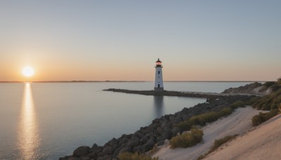 outdoors,sky,cloud,water,tree,no humans,ocean,sunlight,grass,building,scenery,reflection,sunset,rock,sun,horizon,river,tower,landscape,shore,cliff,lighthouse,beach,mountain,sand,road,gradient sky,sunrise,morning