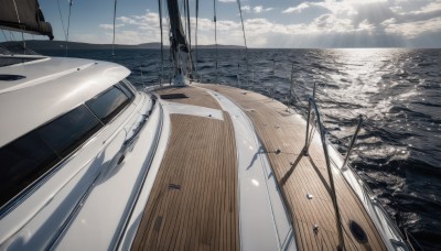 outdoors,sky,day,cloud,water,blue sky,no humans,ocean,sunlight,scenery,horizon,watercraft,ship,boat,dock,cloudy sky,building,light rays,sand,sunbeam