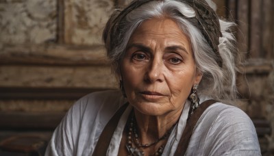 1girl,solo,looking at viewer,shirt,brown eyes,jewelry,closed mouth,white shirt,upper body,white hair,grey hair,earrings,indoors,necklace,blurry,lips,blurry background,suspenders,portrait,freckles,realistic,head scarf,old,pearl necklace,old woman,wrinkled skin,smile,hair bun,depth of field