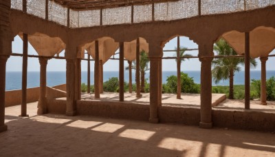 outdoors,sky,day,cloud,water,tree,blue sky,no humans,shadow,ocean,beach,sunlight,scenery,sand,palm tree,shade,pillar,plant,horizon,ruins,column