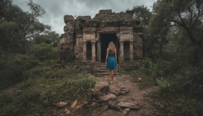 1girl,solo,long hair,skirt,blonde hair,dress,bare shoulders,standing,outdoors,sky,barefoot,sleeveless,cloud,from behind,tree,blue skirt,cloudy sky,grass,plant,nature,scenery,rock,stairs,ruins,wide shot,moss,rubble,overgrown,shirt,day,building,forest,walking,facing away,house,path