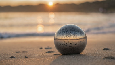 outdoors, sky, blurry, no humans, blurry background, beach, scenery, ball, sunset, sand, sun, still life, desert