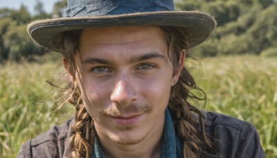 solo,long hair,looking at viewer,smile,brown hair,shirt,1boy,hat,brown eyes,closed mouth,jacket,braid,male focus,outdoors,day,collared shirt,blurry,twin braids,lips,depth of field,blurry background,facial hair,blue shirt,portrait,beard,realistic,nose,mustache,thick eyebrows,grass,denim,denim jacket